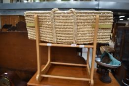 A traditional moses basket on rocking cradle