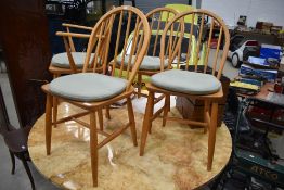 A set of four (three one carver) Ercol hoop and stick back chair, stamped 2056