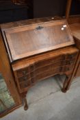 An early 20th Century walnut bureau of nice proportions having four drawer base on cabriole legs ,