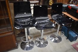Three adjustable chrome kitchen stools