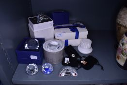 A selection of Swarovski crystal glass decorations including paper weights and badges