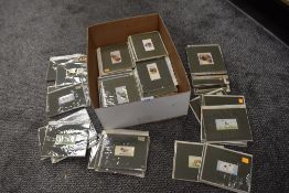 A box full of mounted tea and other collectable cards.