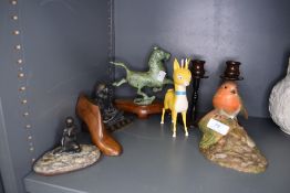 A selection of figures including Babycham advertisement and bakelite candle sticks