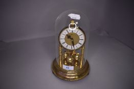 A glass domed anniversary clock K.U.S Germany