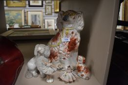 Three staffordshire dogs and two lace figurines.