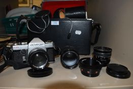A case of vintage camera lenses and accessories, and a Prinzflex Ttl Chinon camera.