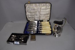 An assortment of flat ware including Fish knives in box , sugar nips, tea spoons and more.
