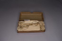 A pair of yellow metal framed spectacles marked 12k with original box