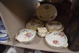 A collection of plates,tureens and a jug having cream ground with floral transfer pattern.
