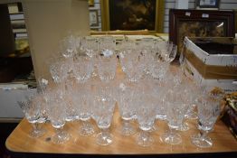 A large collection of cut and etched glasses.