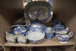 An assortment of blue and white ware including large meat platter, bowls, tureens and more.