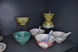 A selection of Chinese hard paste rice bowls including hand decorated with spoons