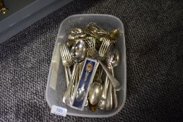 A selection of loose cutlery and flatware with decorative brass wares
