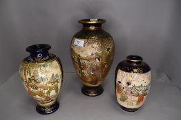 Three Japanese satsuma vase being hand decorated with fantasy and landscape scenes