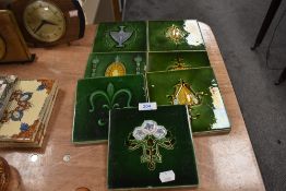 A selection of olive green embossed and glazed Victorian tiles