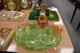 An art deco green glass dressing table set and similar decanter set