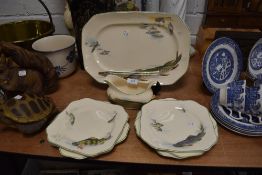 A selection of serving plates by Soho Pottery with a fishing design