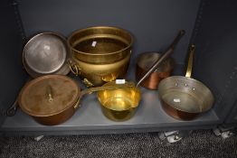 A selection of copper cooking and sauce pans with brass or cast handles