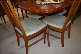 A modern extending dining table with four chairs by Neeson brothers with a matching side board