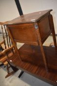 An Edwardian oak framed haberdashery stool or sewing table with fitted interior