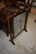 An Edwardian fire screen having barley twist supports