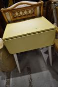 A vintage formica topped drop leaf kitchen table