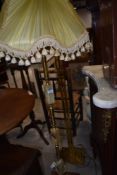 A mid century standard lamp having onyx columns with ormalu