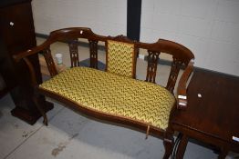 An Edwardian mahogany salon settee having shaped rail and line inlay decoration