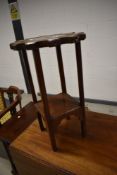 A mahogany framed wheel top table with carved leaf detail