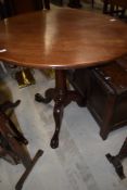 A mahogany framed tilt top tea or wine table having circular top on tripod base
