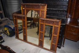 A Victorian overmantel mirror having integrated fretwork decoration, some damage to top beading