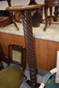 a large torchere or plant stand having barley twist column on tripod base