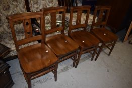 A set of four modern hardwood dining chairs