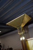 A vintage brass uplighter standard lamp in a Deco style