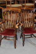 A pair of traditional farmhouse style carver chairs having turned frames and H stretcher