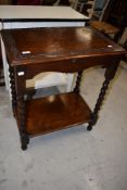 A Jacobean styled side table having storage lid on barley twist legs