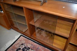 A vintage teak or sapele glazed double bookcase