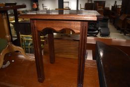 A mahogany low side table with fluted legs