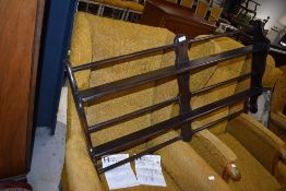 An Ercol dark stained wall shelf