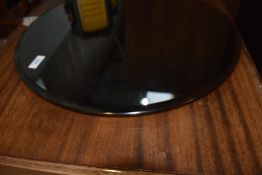 A modern circular framed wall mirror