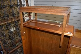 A mid 20th century golden oak bed/occasional table having fixed tray top