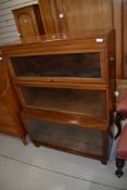 A vintage Minty style three tier stacking bookcase, in a light mahogany