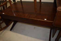 A sapele wood mid century coffee table with drawers and drop leafs