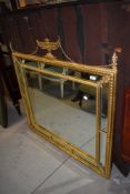 A hall way or over mantle mirror having gilt frame work in a 18th century style