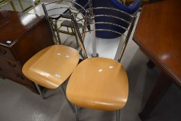 A pair of modern chrome and ply kitchen dining chairs
