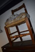 A 19th century beech frame kitchen chair having plentiful sea grass seat