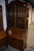 A nice quality early 20th Century mahogany bureau bookcase having ball and claw feet