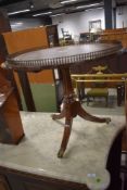 A wine table having brass gallery top with tripod base of lions feet