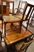 An early to mid 20th Century oak drawer leaf table and four similar chairs, all having barley