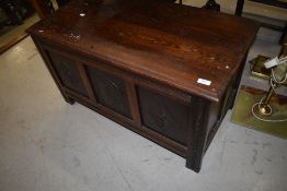 A traditional oak cased bedding box with carved front